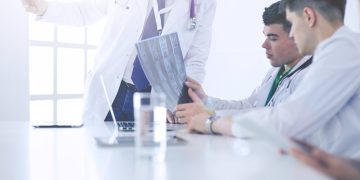 Medical team sitting and discussing at table
